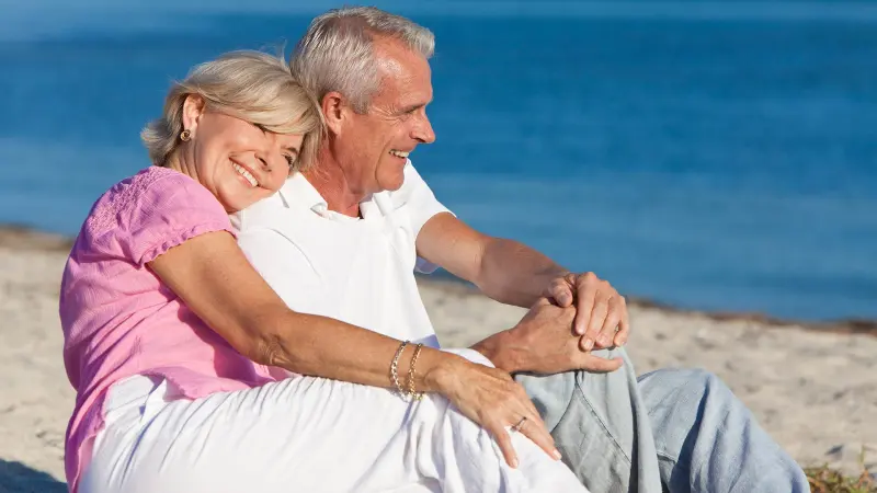 Retired couple relaxing on a beach